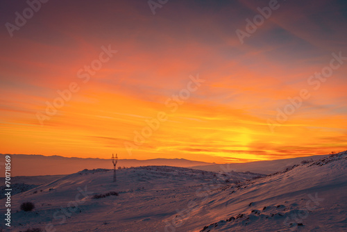 Orange sunset over the Aragats mountains at winter. Travel destination Armenia
