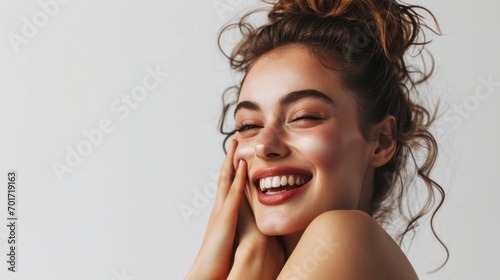 Skincare. Woman with beautiful face touching healthy facial skin. Woman smiling while touching her flawless glowy skin with copy space for your advertisement  skincare