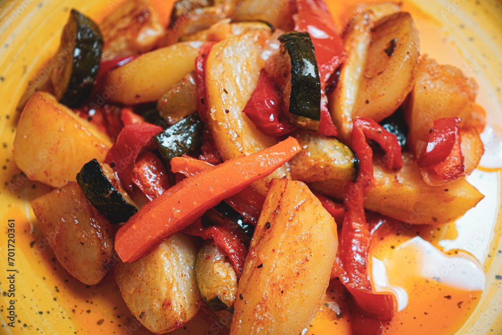 Roasted potatoes with vegetables- carrot, zucchini, bell pepper and onion Roasted potatoes with vegetables- carrot, zucchini, bell pepper and onion