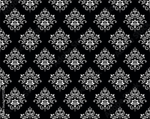 Wallpaper in the style of Baroque. Seamless vector background. White and black floral ornament. Graphic pattern for fabric, wallpaper, packaging. Ornate Damask flower ornament
