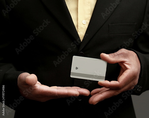 businessman with blank white card on grey black background with people stock image stock photo
