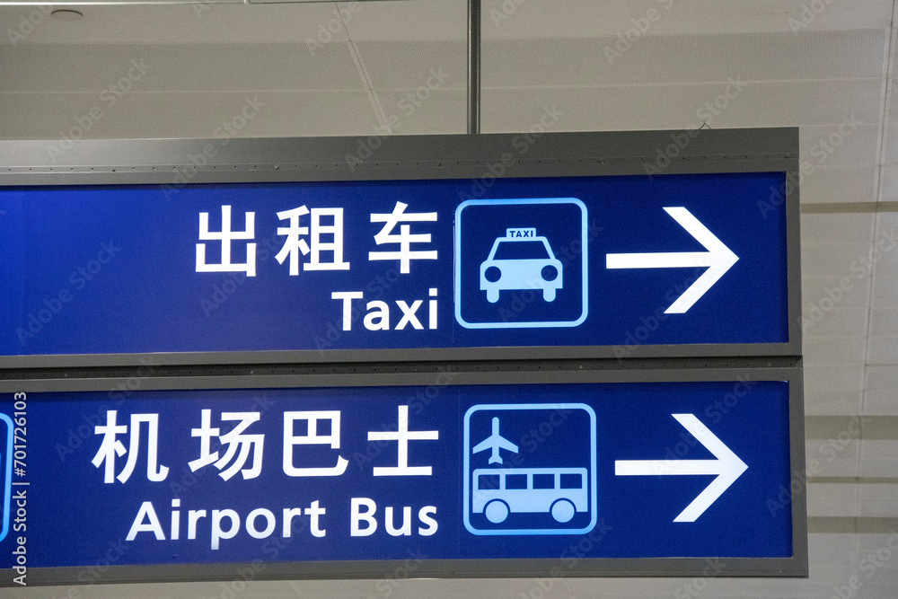 Taxi and airport bus sign hanging from ceiling