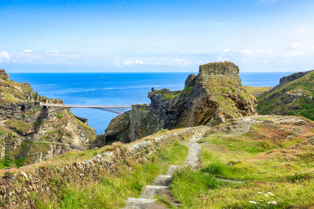 Tintagel Castle, Cornwall, UK - and its famous double cantilever bridge, from the South West Coast Path. The castle is the legendary birthplace of King Arthur.