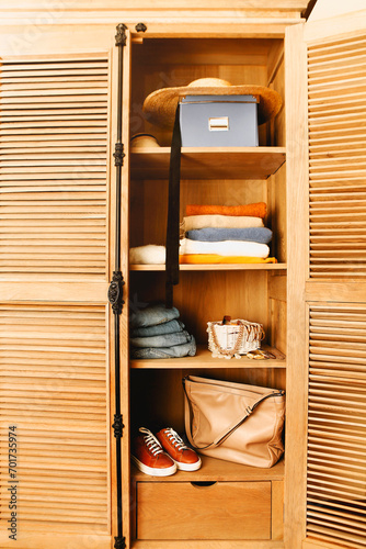 Casual clothes, shoes, bag and jewelry in a wardrobe in retro style