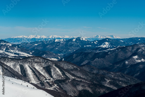 Tatra mountains and nearer Salatin hill in Nizke Tatry mountains from Krizna hill in winter Velka Fatra mountains photo