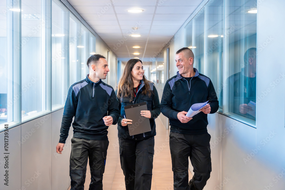 Workers of a logistic factory chatting and walking indoors