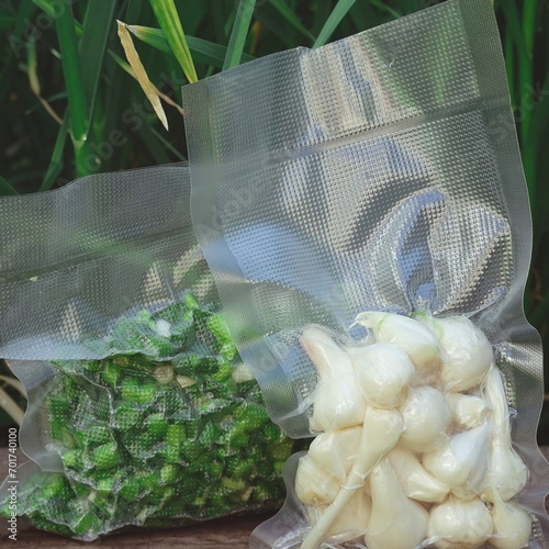 Plastic Vacuum Packing. Degassing. Long-term storage of products. Garlic in cellophane packet photo