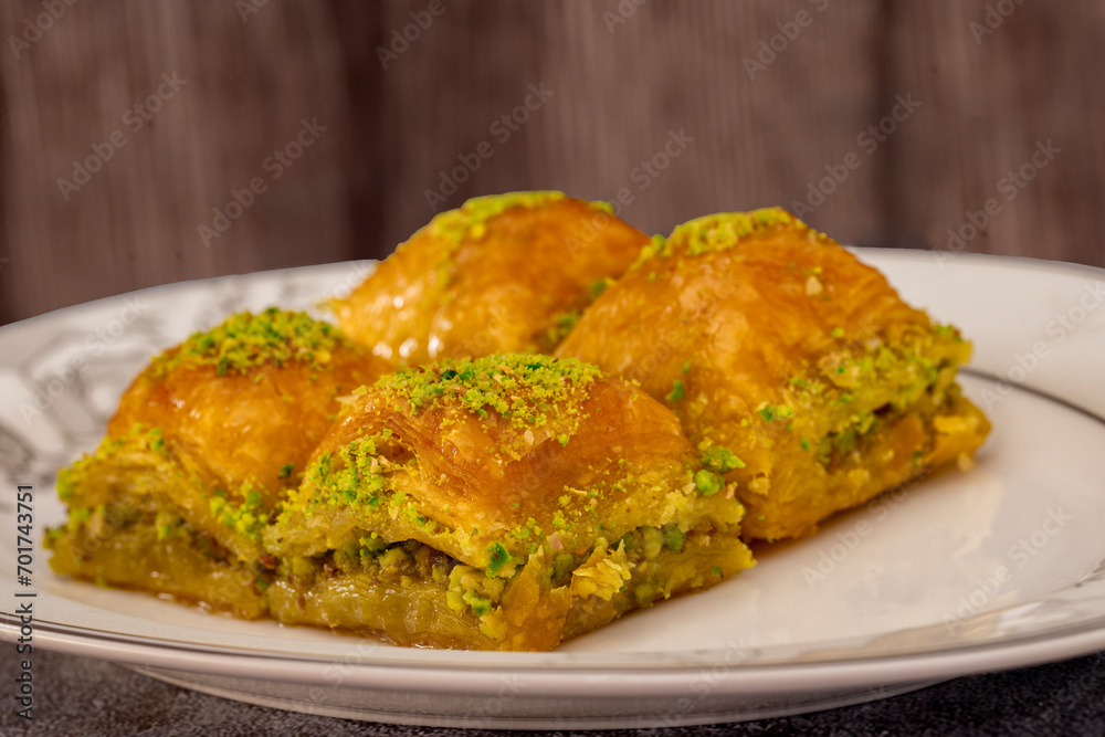 Pistachio Turkish baklava on a white plate.Traditional delicious Turkish baklava Pistachio Turkish baklava on a white plate.Traditional delicious Turkish baklava