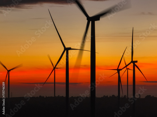 Wind farm landscape against sunset sky. Wind energy. Wind power. Sustainable and renewable energy. Wind turbines generate electricity. Green technology. Renewable resources. Sustainable development.