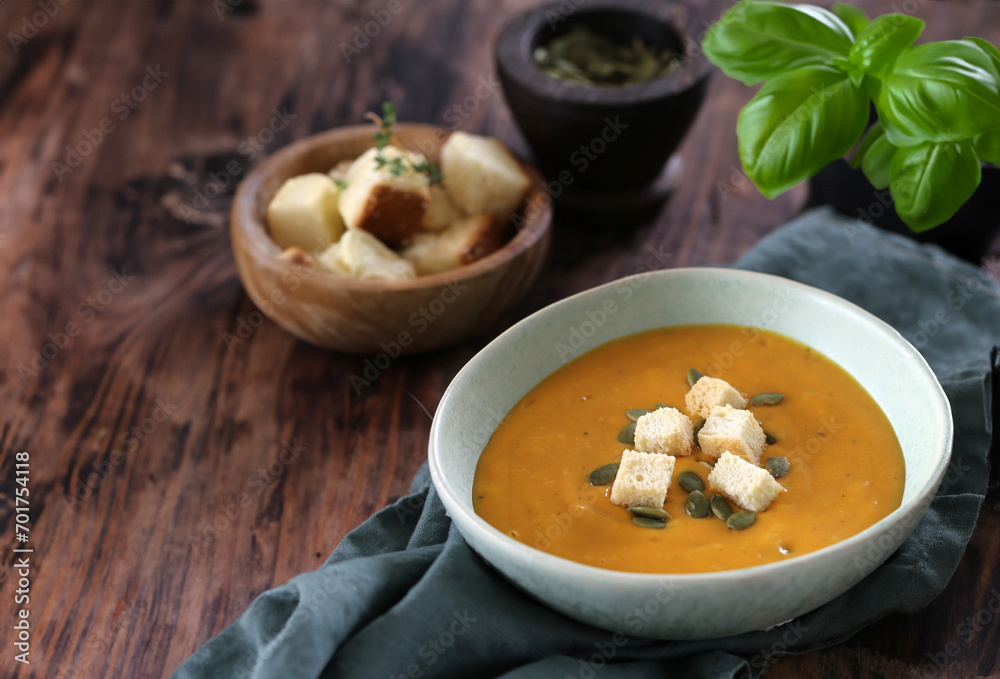 pumpkin cream soup with croutons in a bowl