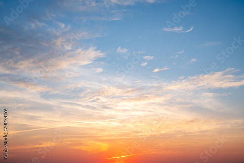 Fototapeta Naklejka Na Ścianę i Meble -  Beautiful of luxury soft gradient orange gold clouds and sunlight on the blue sky perfect for the background, take in everning,Twilight