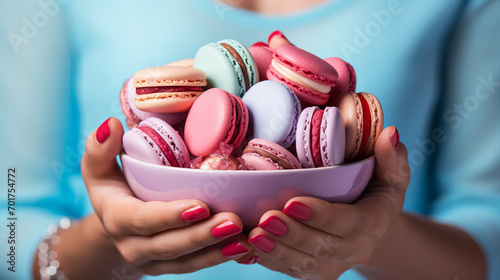 Woman holding plate with macaroons. Food and pleasure concept, copy space, Valentine day, Easter celebration, Birthday party, Mother day, International Women day