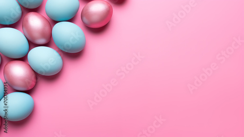 Colorful easter eggs on pink background. Top view with copy space 
