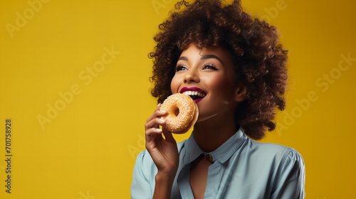 african american woman holding eating donut isolated on yellow background, junk unhealthy food diet concept copy space, Valentine day, sweet tasty life, Valentine day, International Women day, 8 March