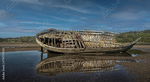 Washed up hulk of wooden fishing boat