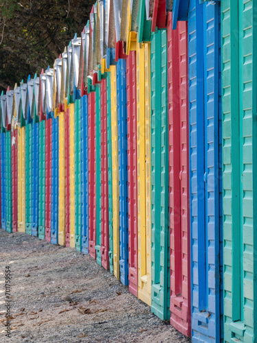 A row of brightly coloured beach huts