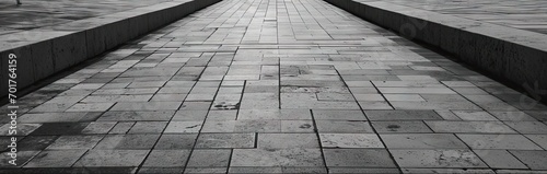 Detailed view of textured square pavement. Cobblestone charm. Vintage patterns on ancient urban path. Concrete symphony. Grey and black pavement in city