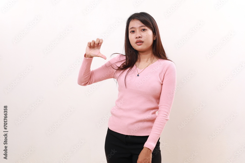 Young asian girl standing while holding something. Isolated on white background Young asian girl standing while holding something. Isolated on white background