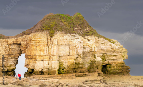 North Yorkshire beach and rock arch with people
