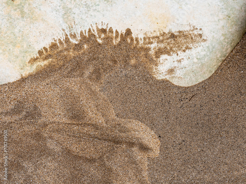 Abstract sand pattern against chalk boulder