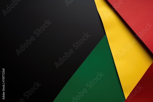 Red, yellow and green abstract color paper on black background. Black History Month Flat lay. Copy space