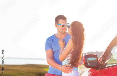 Young smile couple romantic standing by the car at summer