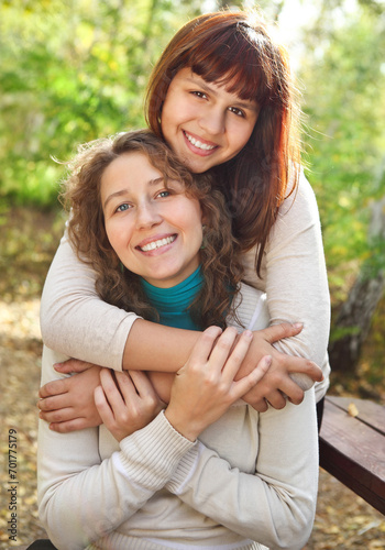 Young smiling woman with her teen daughter © Dasha Petrenko