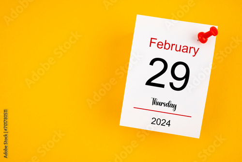 February 29th calendar for February 29 and wooden push pin on yellow background. photo