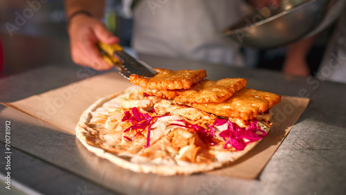 Close Up Of Man Making Takeaway Wrap In Food Van At Outdoors Summer Music Festival