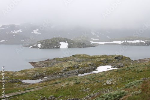 landscape with lake and mountains with snow in Norway © Tomas