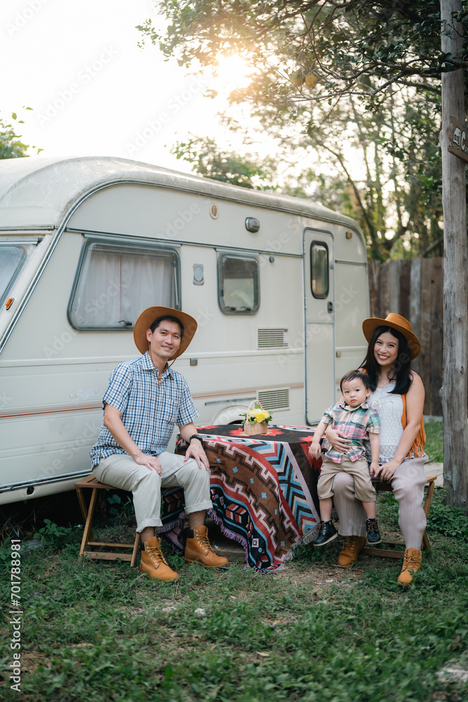 An Asian multiracial family with children are camping in nature on a road trip. Dad and mom daughter and son in the woods in the summer. Selective focus