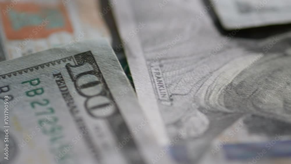 Macro video shooting. One hundred dollar bill paper texture. Portrait of President Franklin on money and the number one hundred. The concept of finance and currency operations. Macro video shooting. One hundred dollar bill paper texture. Portrait of President Franklin on money and the number one hundred. The concept of finance and currency operations.