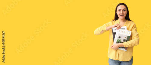 Beautiful woman with interior design magazines on yellow background with space for text