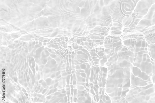 White water with ripples on the surface. Defocus blurred transparent white colored clear calm water surface texture with splashes and bubbles. Water waves with shining pattern texture background. photo