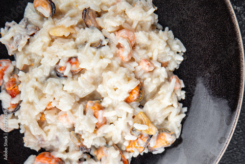 risotto seafood mussel, squid, shrimp fresh rice cooking meal food snack on the table copy space food background rustic top view Pescetarian diet