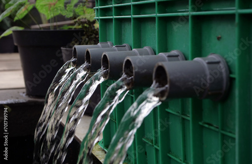 Water flows from a pipe. Clean water flows in a pipe after being filtered in a fish pond