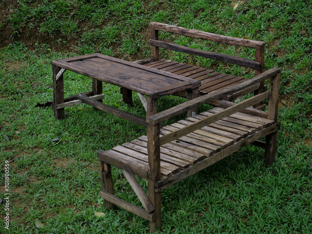 old wooden tables and chairs in the forest old wooden tables and chairs in the forest