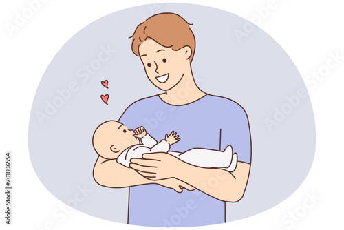 Happy father holding baby in arms