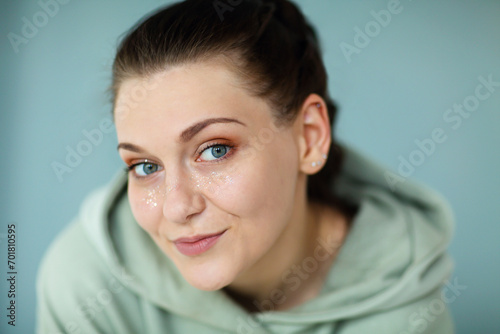 Beautiful portrait of young happy cheerful 30s woman in casual sweatshirt looking straight at camera