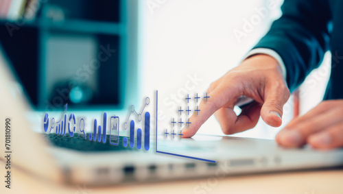 Fototapeta Naklejka Na Ścianę i Meble -  investment and financial trading in stock market concept businessman using computer laptop in modern office analysing virtual trading price graph