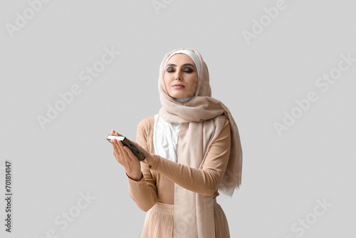 Young Muslim woman with Kor...