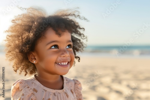 Portrait of Smiling African child girl in swimwear and swim ring playing on tropical beach in summer sunny day. Happy little girl enjoy and fun outdoor activity lifestyle on travel vacation at the sea photo