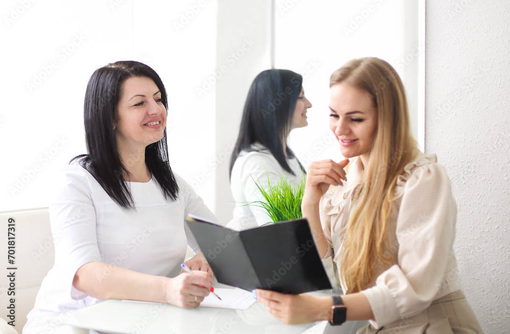 Smiling woman talking to beautician in salon Smiling woman talking to beautician in salon