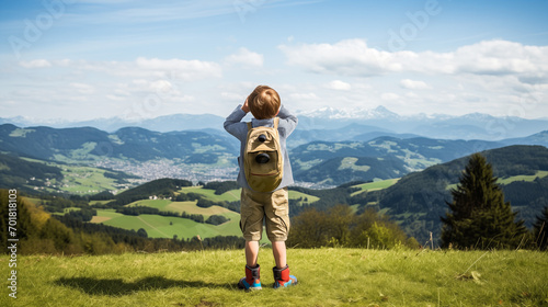 A child looking through binoculars at the panoramic views of the Jura Mountains. © XaMaps