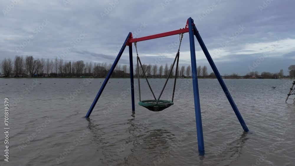 Swings in Submersion: Riverside Playground Submerged by the Lek River Swings in Submersion: Riverside Playground Submerged by the Lek River