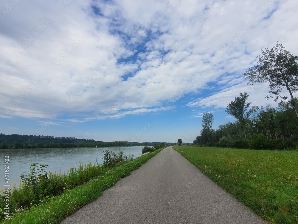 Beautiful bike path at famous Danube River: Donauradweg next to the river on a sunny day with clear blue sky and copy space for text, austria