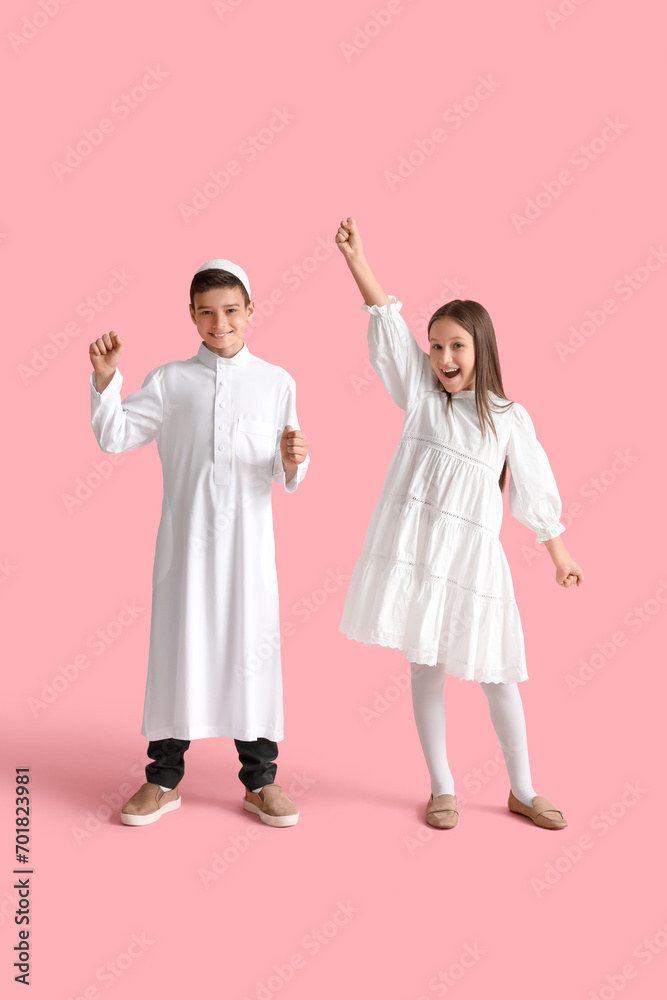 Happy little Muslim children on pink background