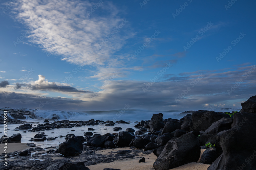 Long exposure view of waves crashing on the rocky shore of Benares beach located on the south coast of Mauritius island Long exposure view of waves crashing on the rocky shore of Benares beach located on the south coast of Mauritius island