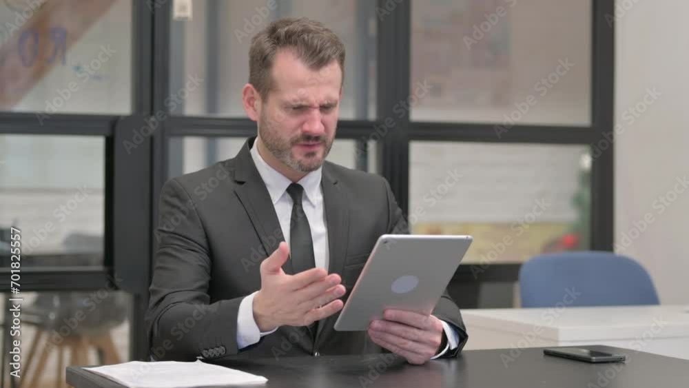 Upset Businessman with Loss on Tablet Upset Businessman with Loss on Tablet