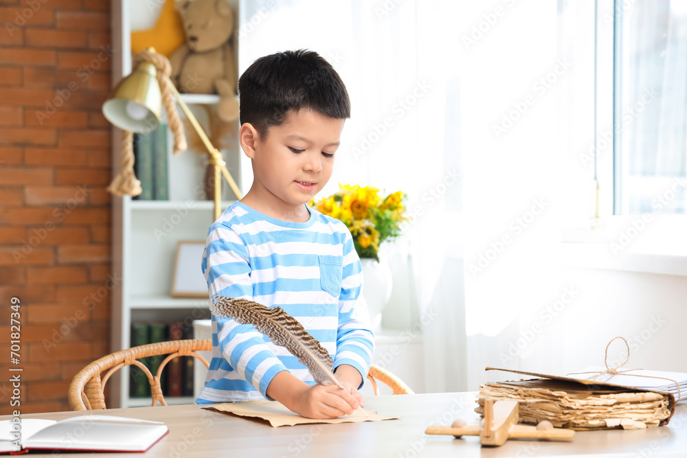 Cute little boy with adventure book writing at home Cute little boy with adventure book writing at home